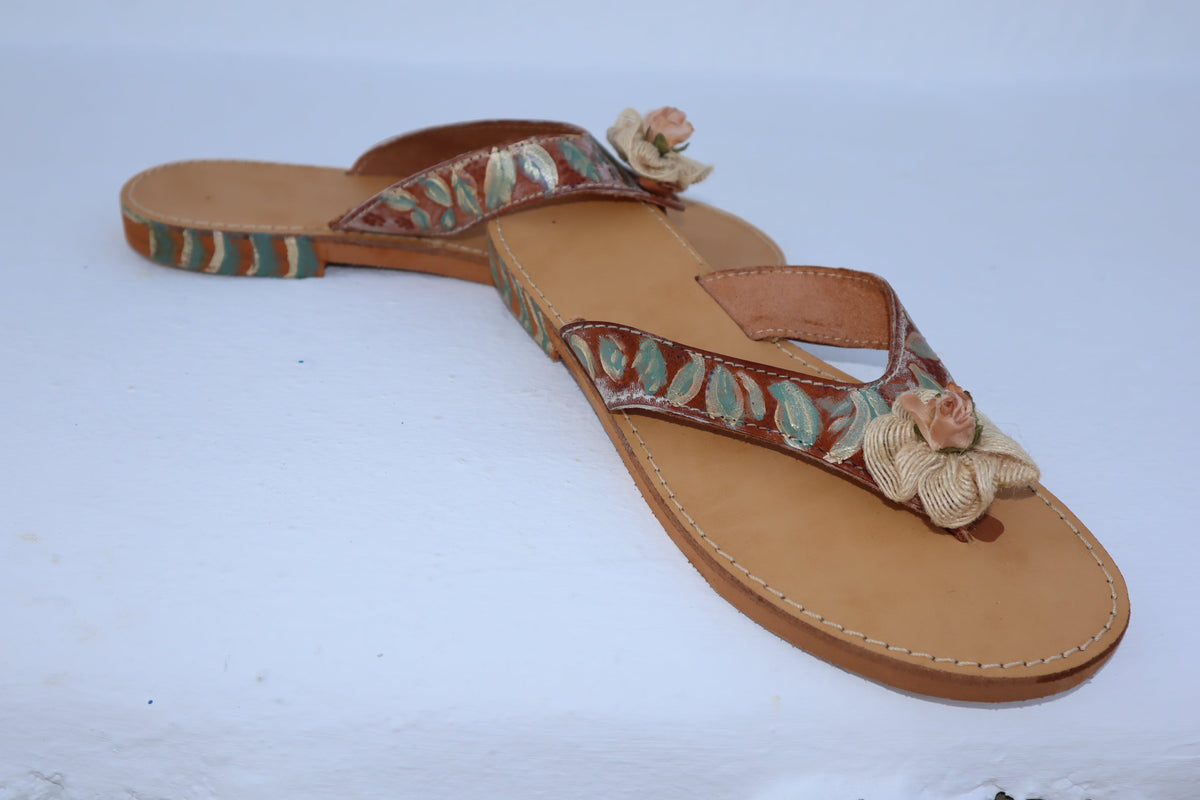 CLOSE UP DETAIL OF HAND-PAINTED ROSE ON TILOS SANDALS